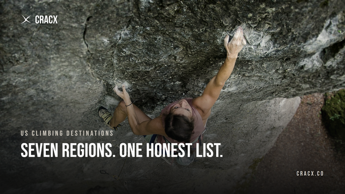 A climber reaching for a chalked hold on steep grey rock, shot from above