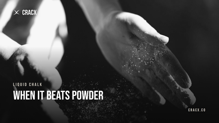 Chalk dust falling from a climber's hands after chalking up — the dust liquid chalk avoids