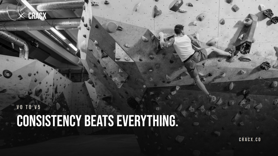 A boulderer high on a steep gym wall covered in holds and volumes