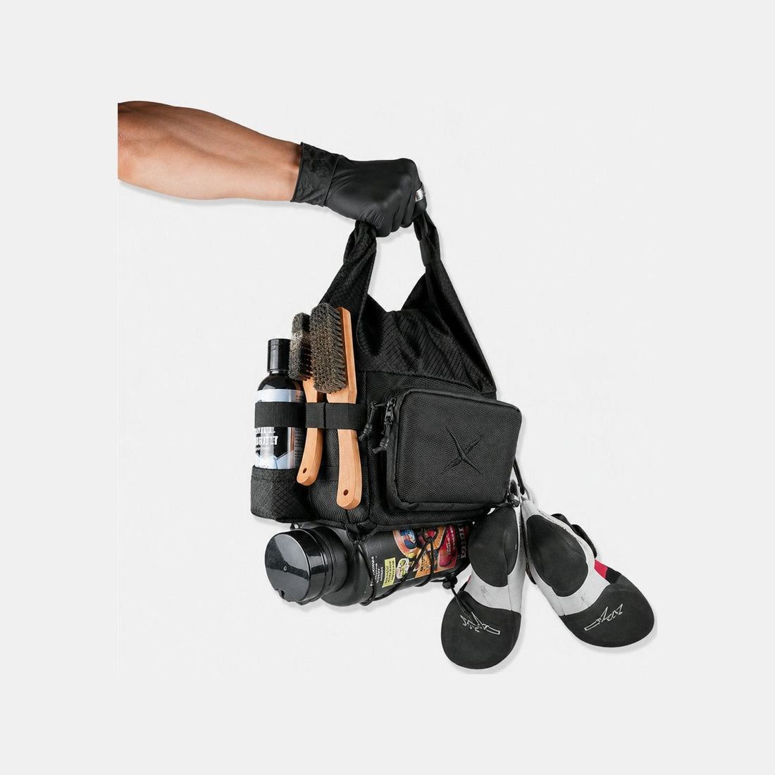 Bouldering chalk bucket loaded with climbing shoes, brush and chalk — a boulder bag that carries a whole session