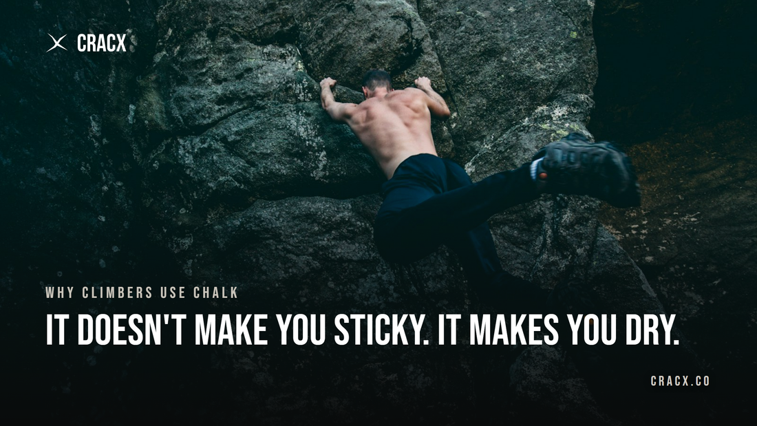A climber pulling on rock above water, hands the only point of contact
