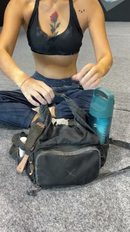 Climber packing a worn CRACX Ascend prototype on the gym floor