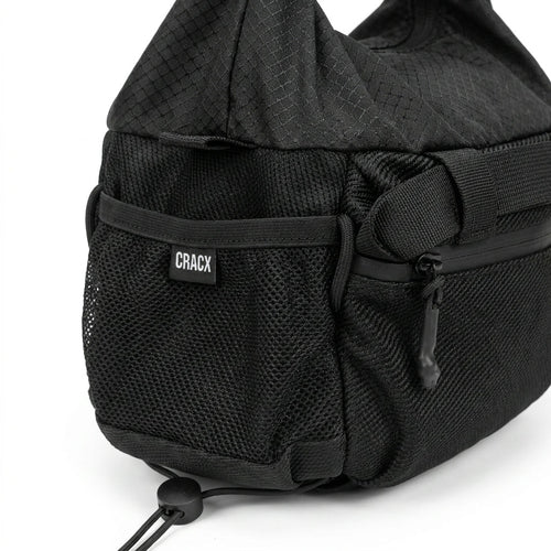 Close-up of the stretch mesh side pocket and woven CRACX label on the Ascend